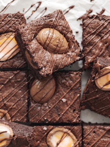 Squares of creme egg brownies with chocolate drizzle