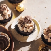 ferrero rocher cupcake on plate topped with chocolate buttercream