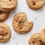 A bite taken out of a cookie surrounded by several cookies