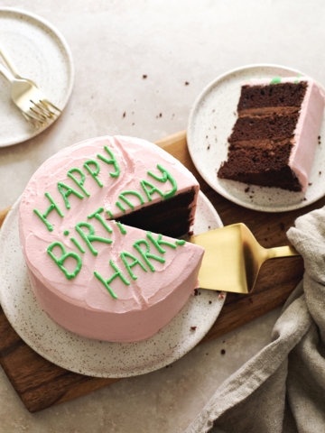 Chocolate birthday cake with slice cut out of it