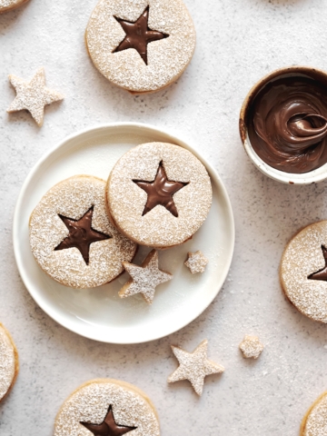 Hazelnut linzer cookies with star cut outs on table