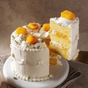 A slice of mango chiffon cake lifted from the cake with a cake server.