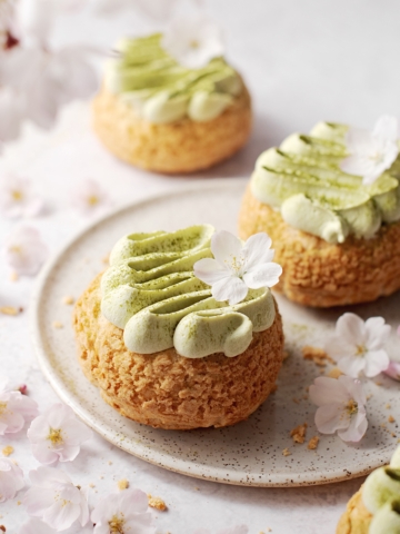 Matcha cream puffs surrounded by cherry blossoms