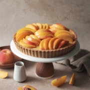 Peach custard tart on a cake stand