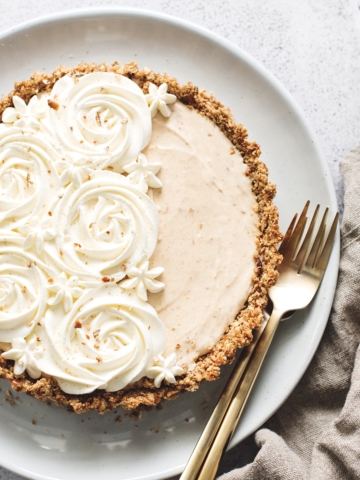 Peanut butter ice cream pie with whipped cream rosettes and brown linen