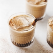 Close up of pumpkin spice white russian cocktails and large ice cubes