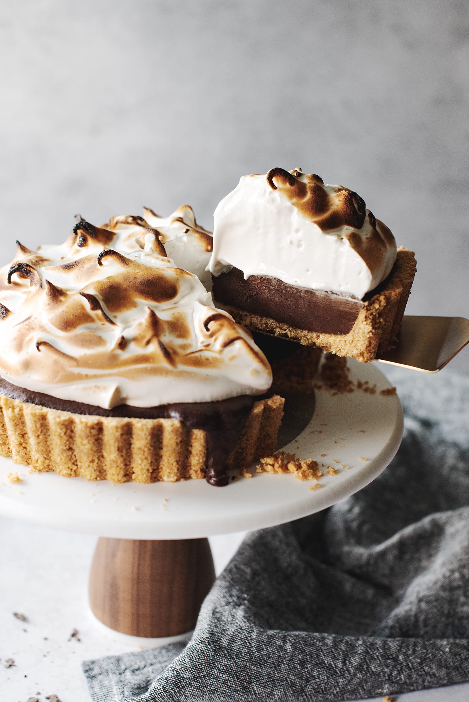 Piece of s'mores tart lifted away from the entire tart