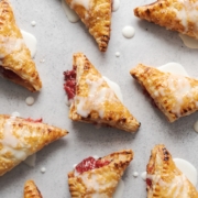 Strawberry pies laid out on a grey background