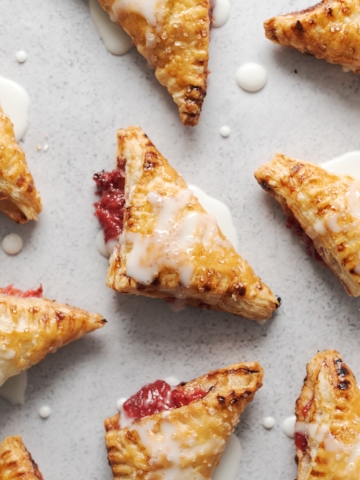 Strawberry pies laid out on a grey background