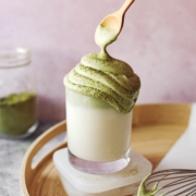 Spoon lifting whipped matcha cream from dalgona matcha latte