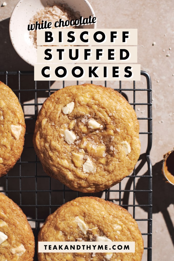 Biscoff stuffed cookies on a wire rack with text overlay that says โwhite chocolate biscoff stuffed cookiesโ.