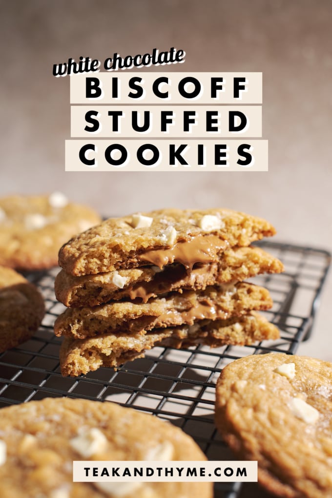 Stack of cookies broken in half to show biscoff filling in the middle with text overlay that says โwhite chocolate biscoff stuffed cookiesโ.