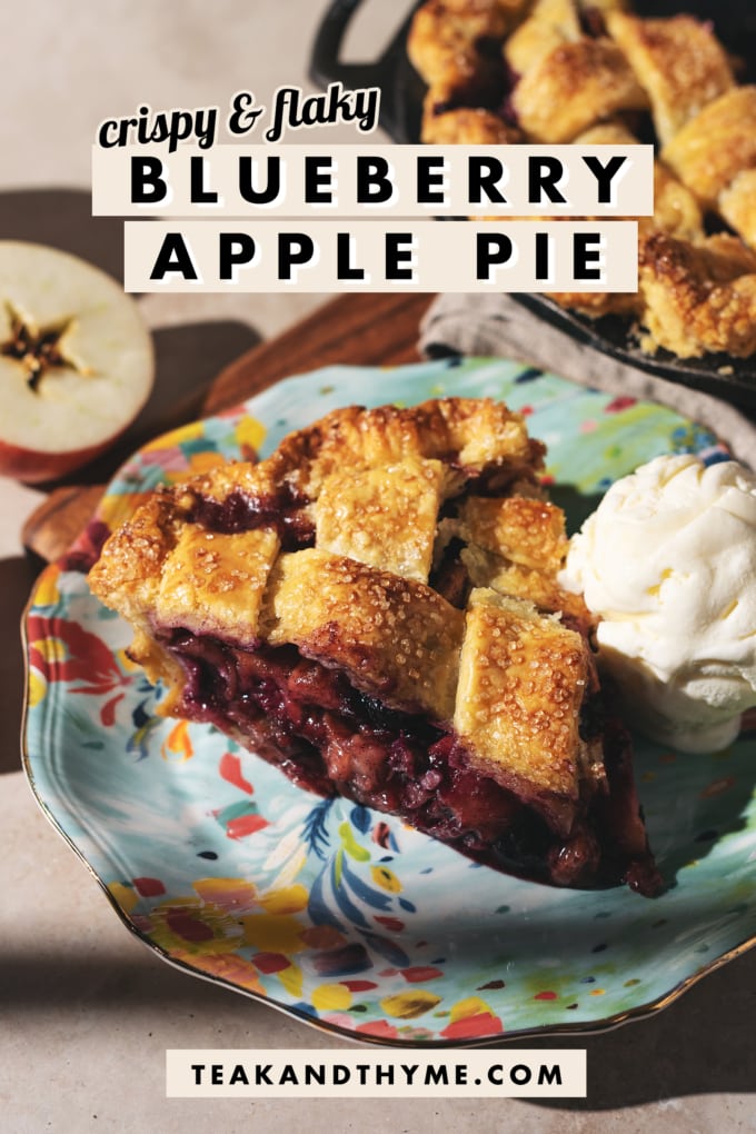 A slice of blueberry apple pie on a plate with a text overlay that says โcrispy & flaky blueberry apple pieโ.