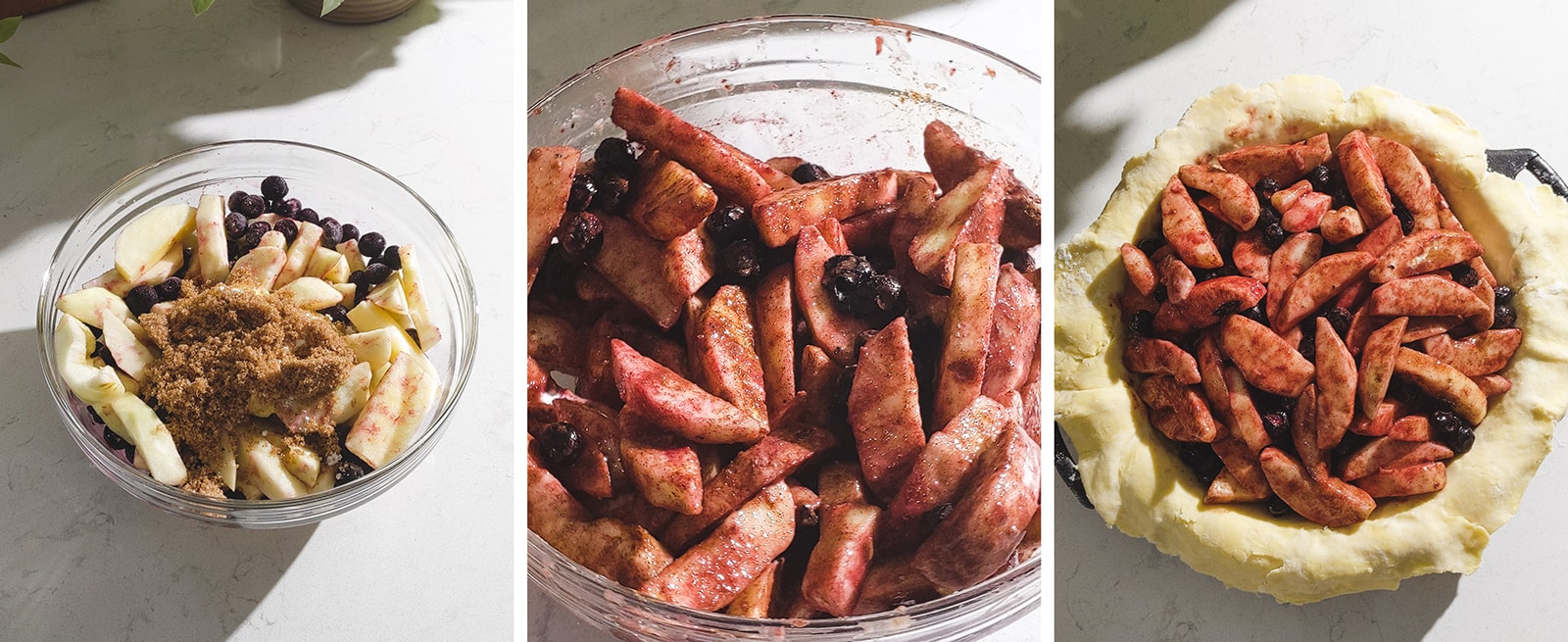 Mixing blueberries and apples together and putting it in a pie crust.