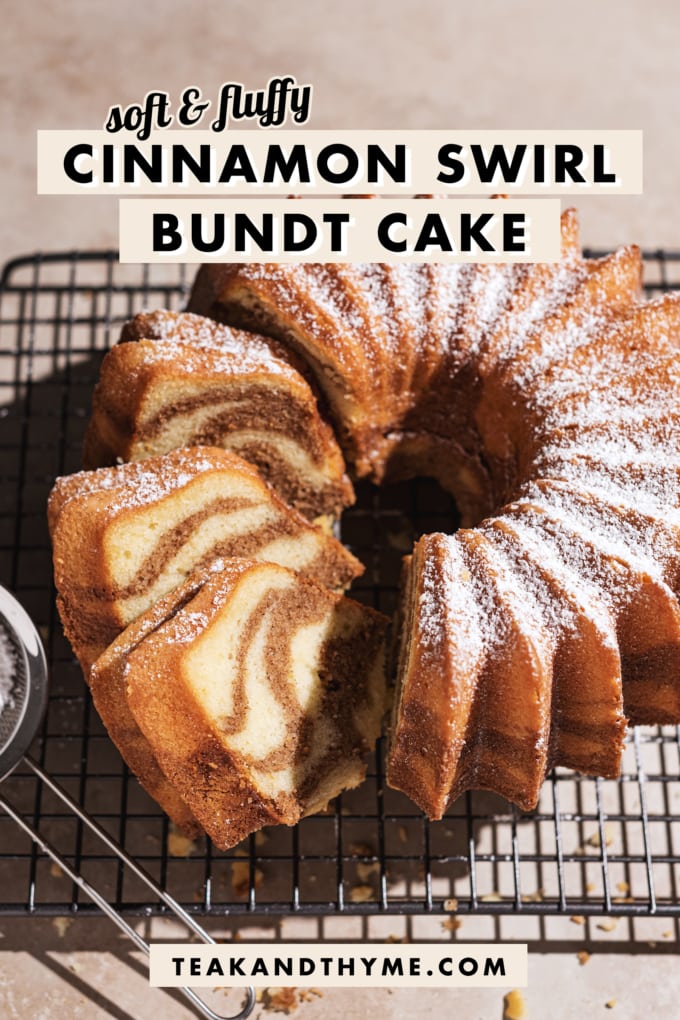 Cinnamon swirl bundt cake on wire rack with three slices cut from one side.