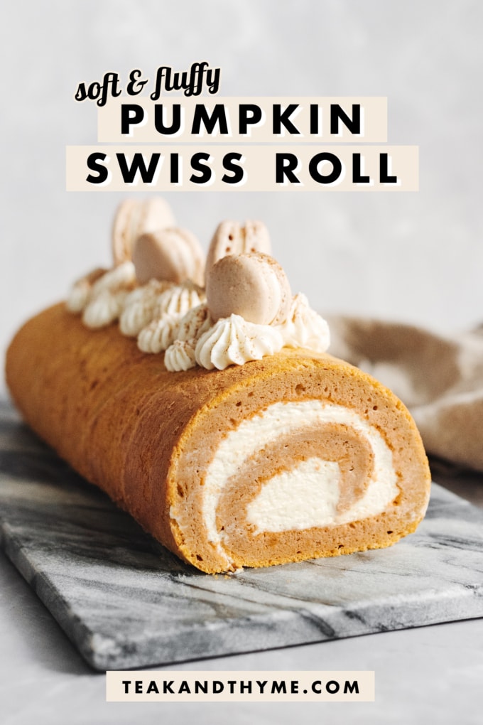 A pumpkin swiss roll on a stone platter.