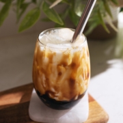 Glass drizzled with brown sugar syrup and filled with milk and boba.