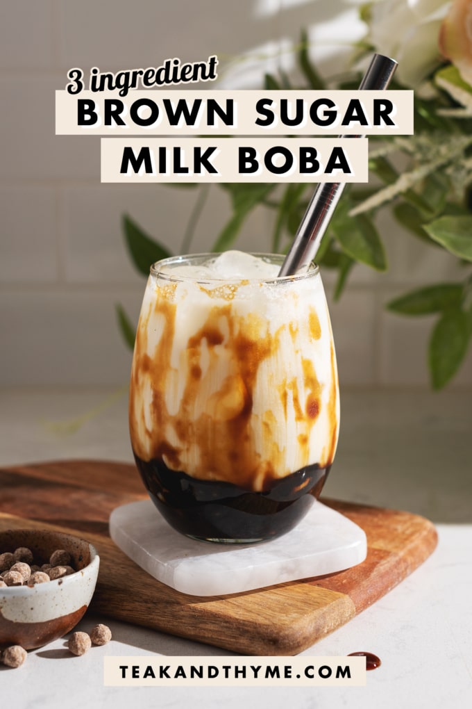 Glass of brown sugar milk boba on a coaster.