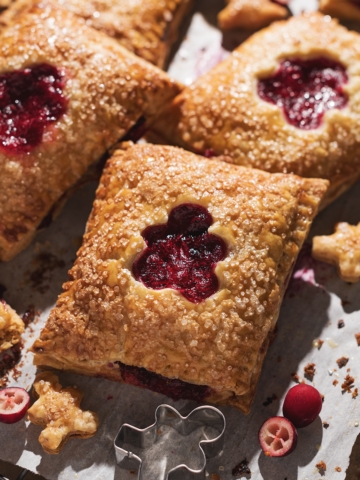 Close up of a cranberry hand pie with a gingerbread man cutout.