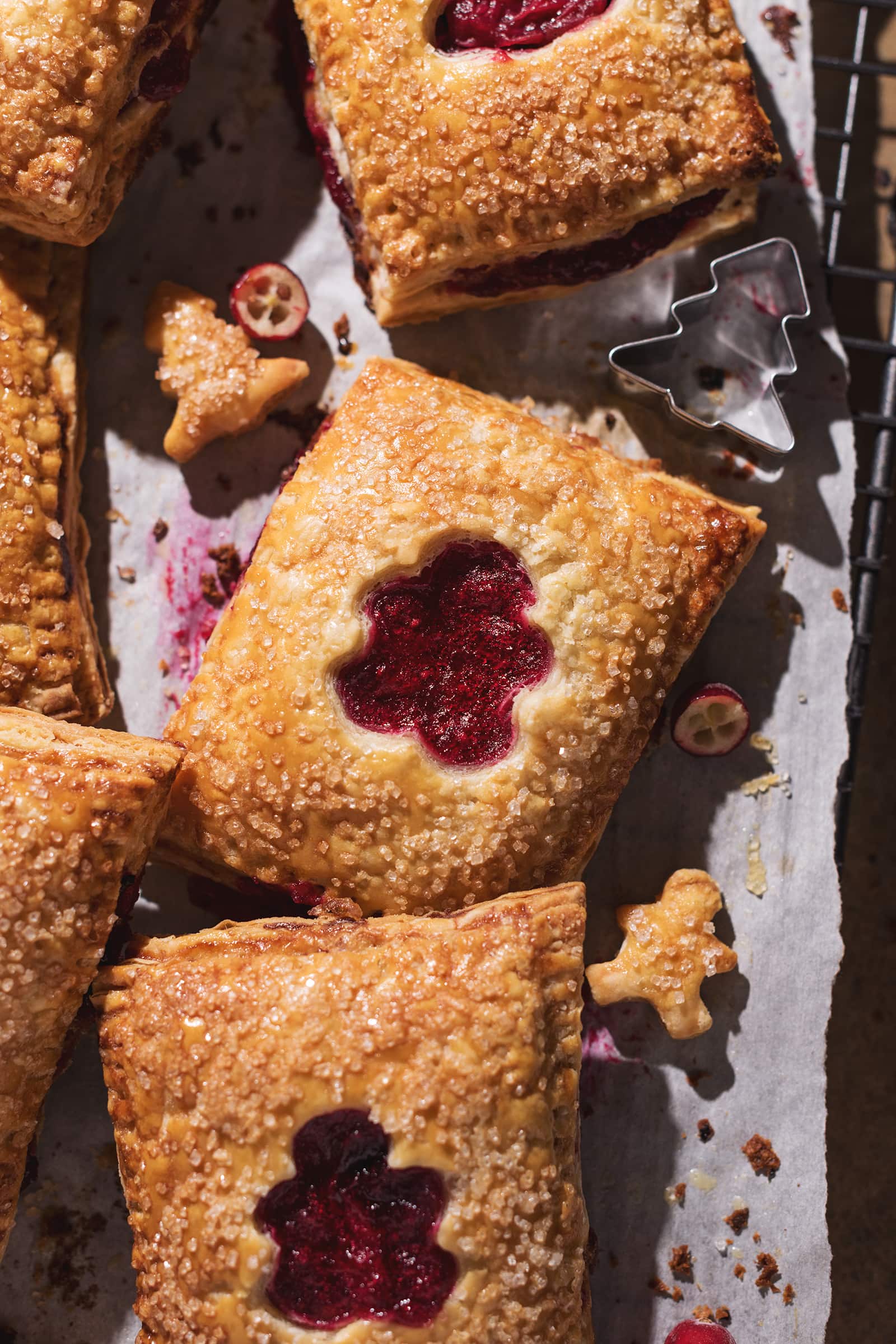 Close up of a hand pie with a cut out showing the cranberry filling inside.