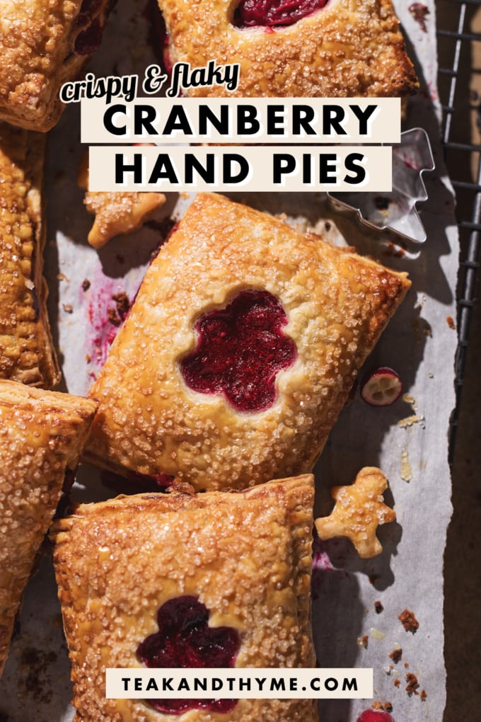 Close up of a hand pie with a cut out showing the cranberry filling inside.