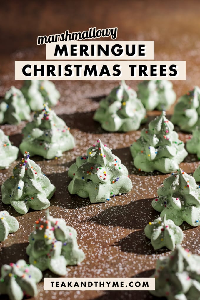 Meringue christmas trees sprinkled in powdered sugar.