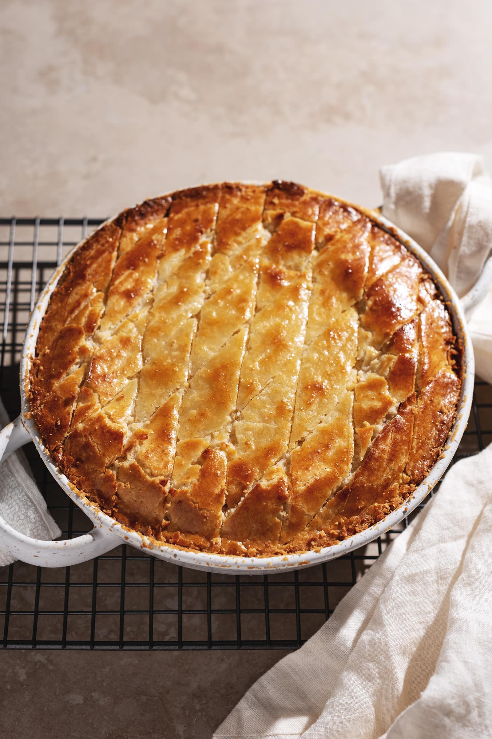 Tapioca pudding in a baking dish with golden brown pineapple bun crust on top.