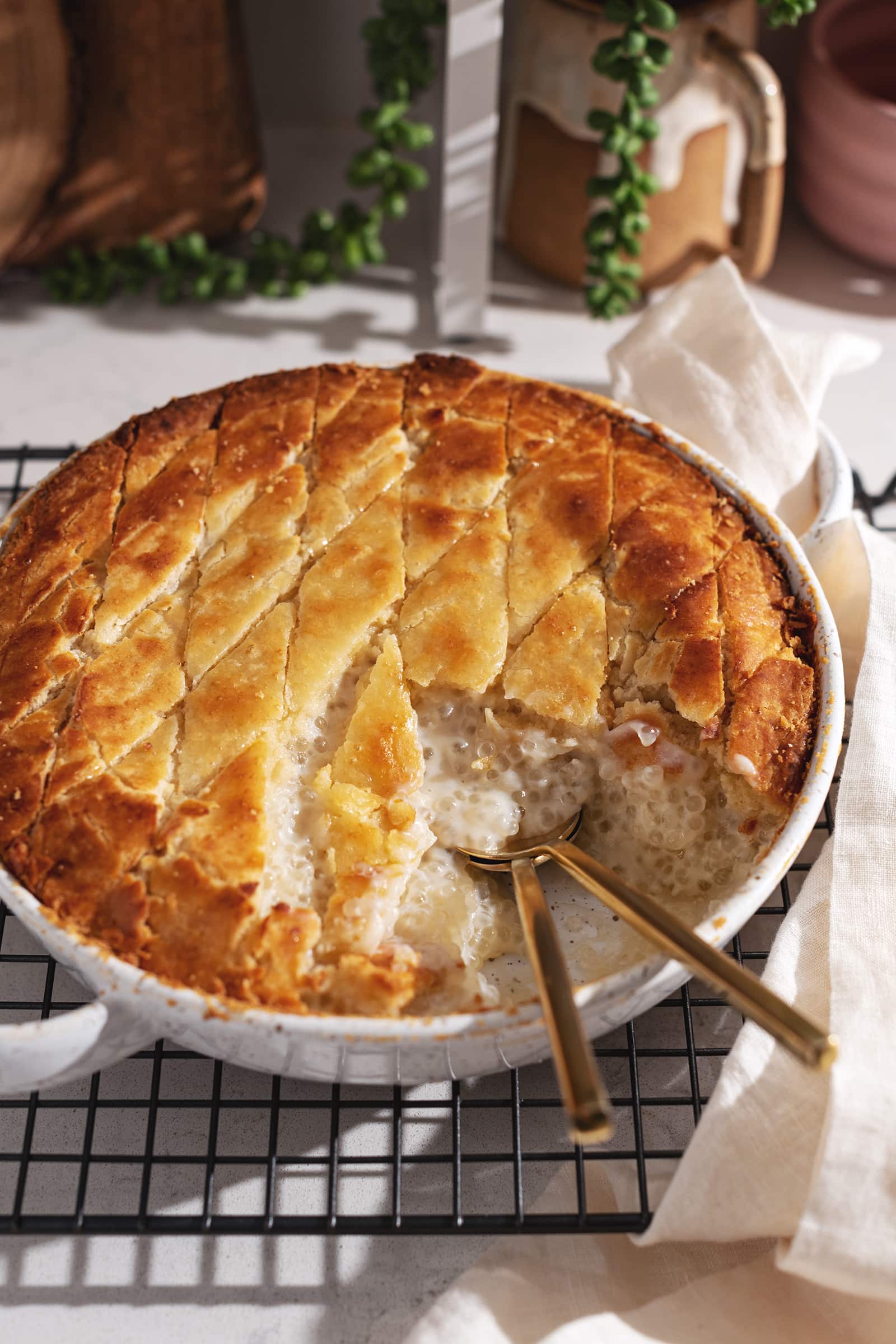 A scoop taken out of a baked tapioca pudding to show the sago pearls inside.