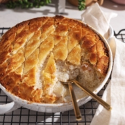 A scoop taken out of a baked tapioca pudding to show the sago pearls inside.