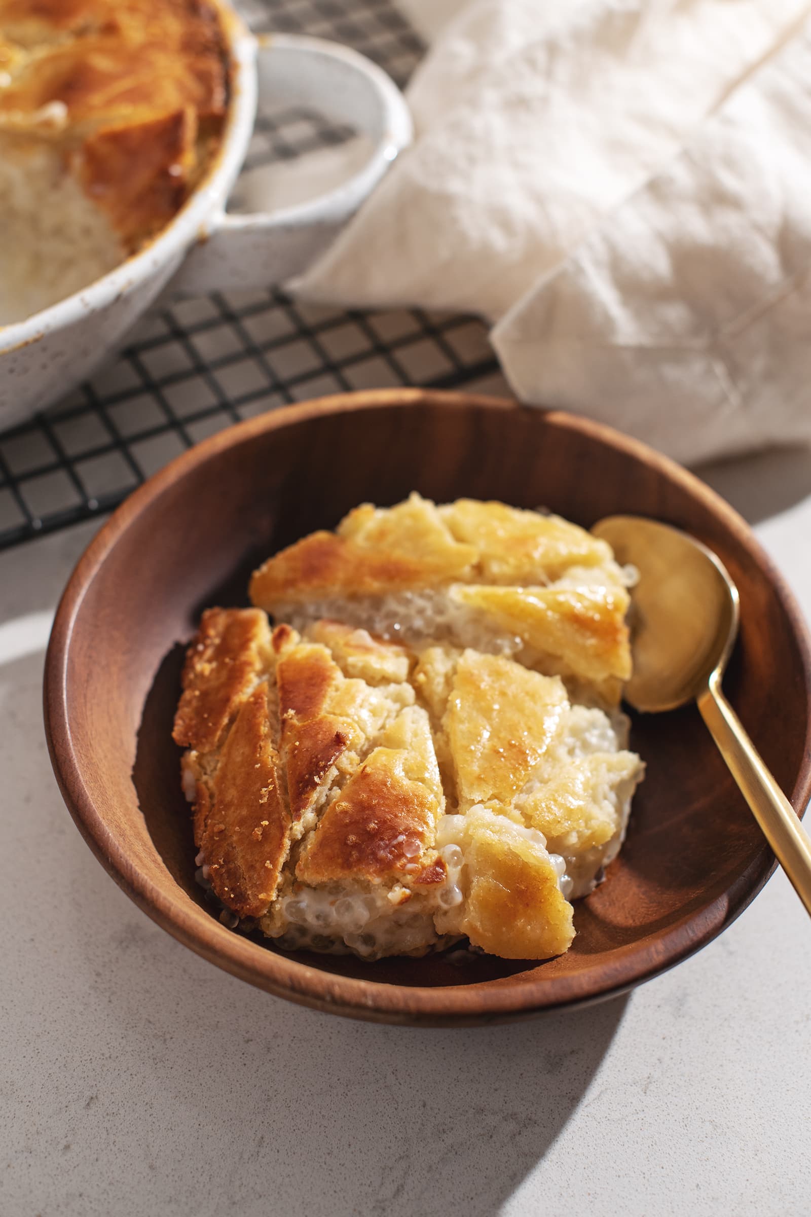 A portion of baked tapioca pudding in a wooden bowl.