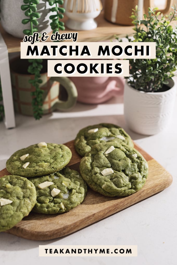 Matcha mochi cookies on a wooden board in front of a shelf.