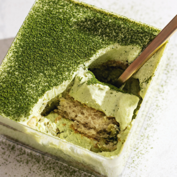 A scoop of matcha tiramisu resting in its container.