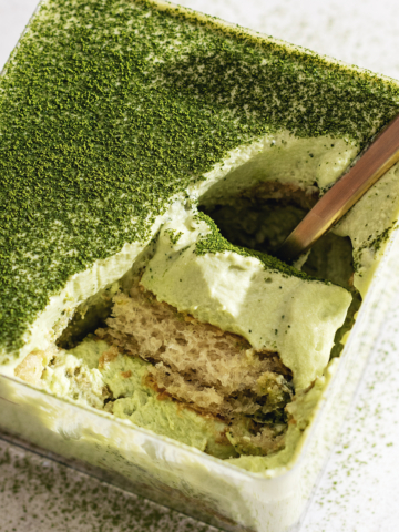 A scoop of matcha tiramisu resting in its container.