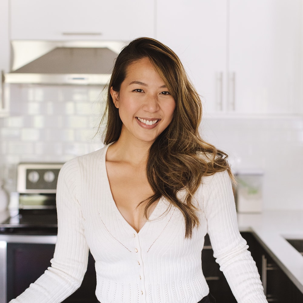 Girl standing in front of kitchen.