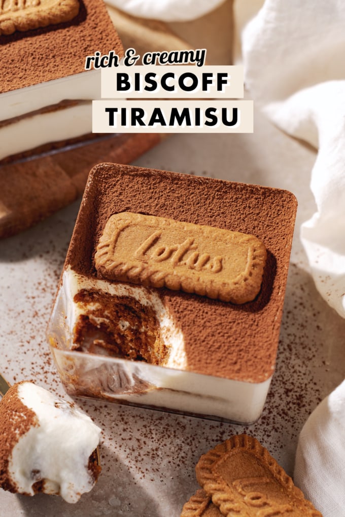 A square container of biscoff tiramisu with a spoonful scooped out of one corner.