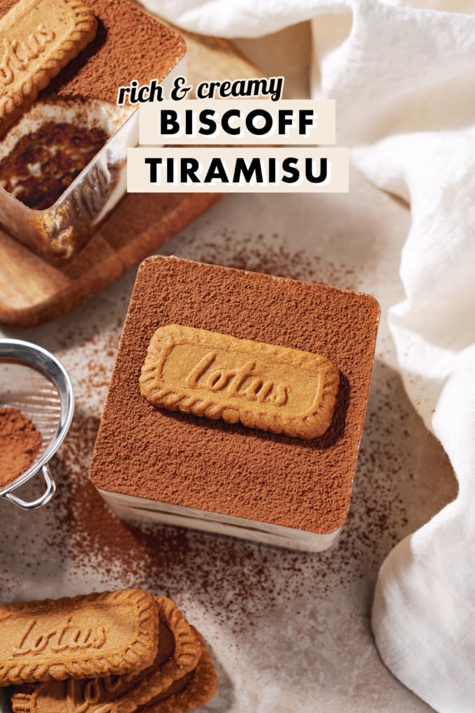 A box of biscoff tiramisu dusted with cocoa powder with a Lotus biscuit on top.