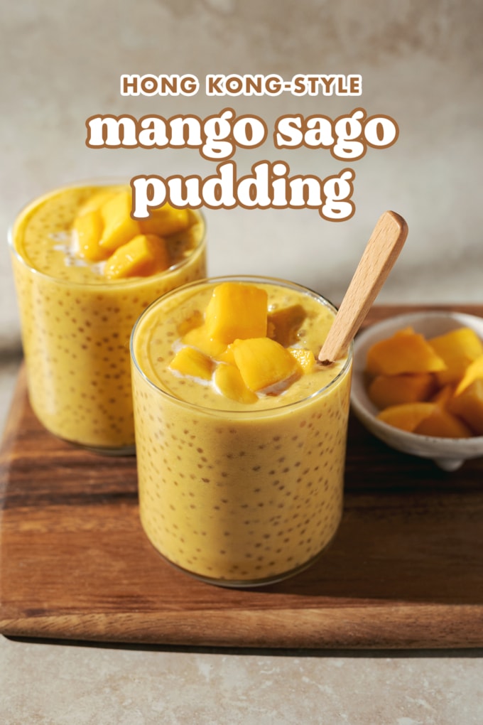 Two glasses of mango sago topped with mango chunks on a wooden platter with text overlay that says โhong kong style mango sagoโ.