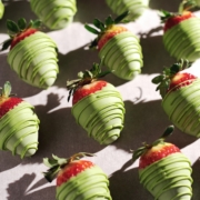 Matcha-covered strawberries lined up in rows.