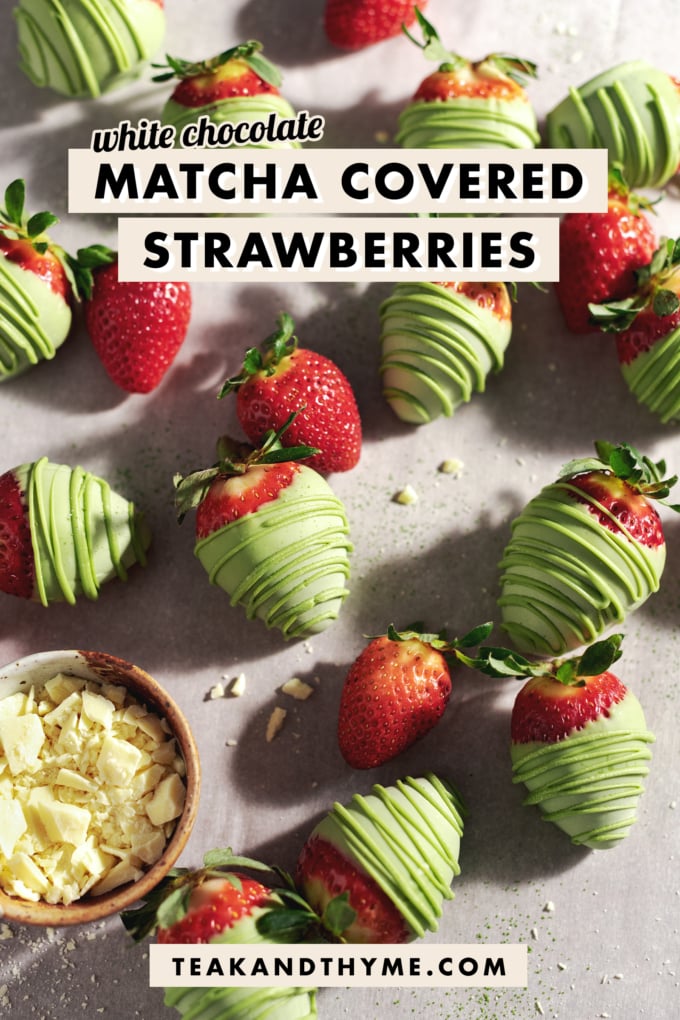 Matcha-covered strawberries scattered on table with fresh strawberries and a bowl of white chocolate.