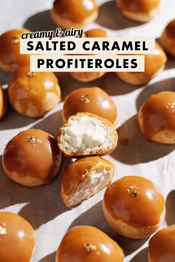 Salted caramel profiterole cut in half to show whipped cream filling inside.