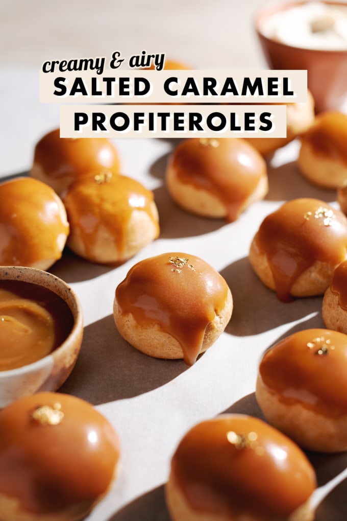 Profiterole with a caramel drip down the side surrounded by more cream puffs.