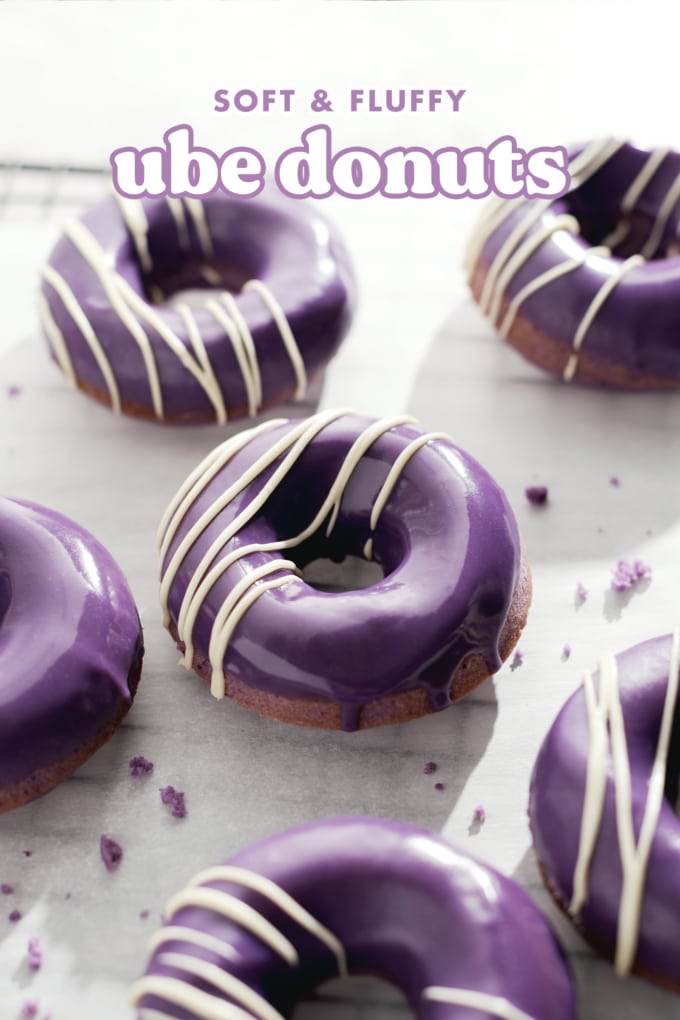 Ube donut with purple glaze dripping down the side.