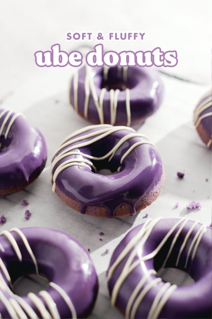 Ube donuts with purple glaze dripping down the front.