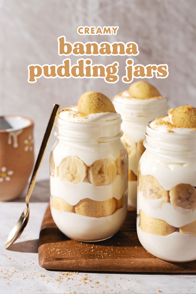 Three banana pudding jars with a spoon resting on the side.