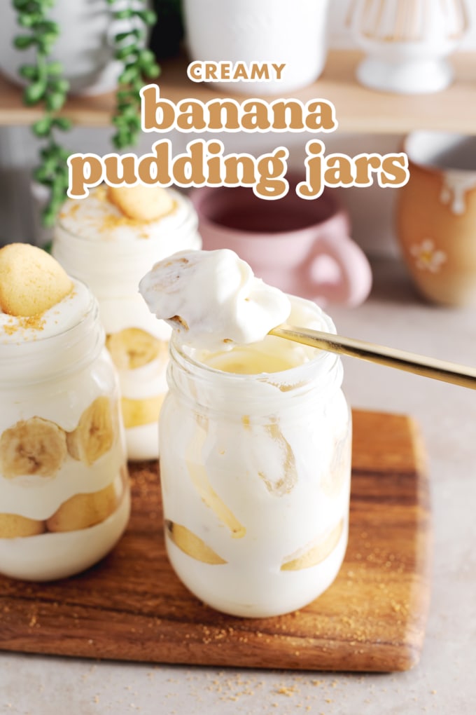 Spoonful of banana pudding rest on top of jar.