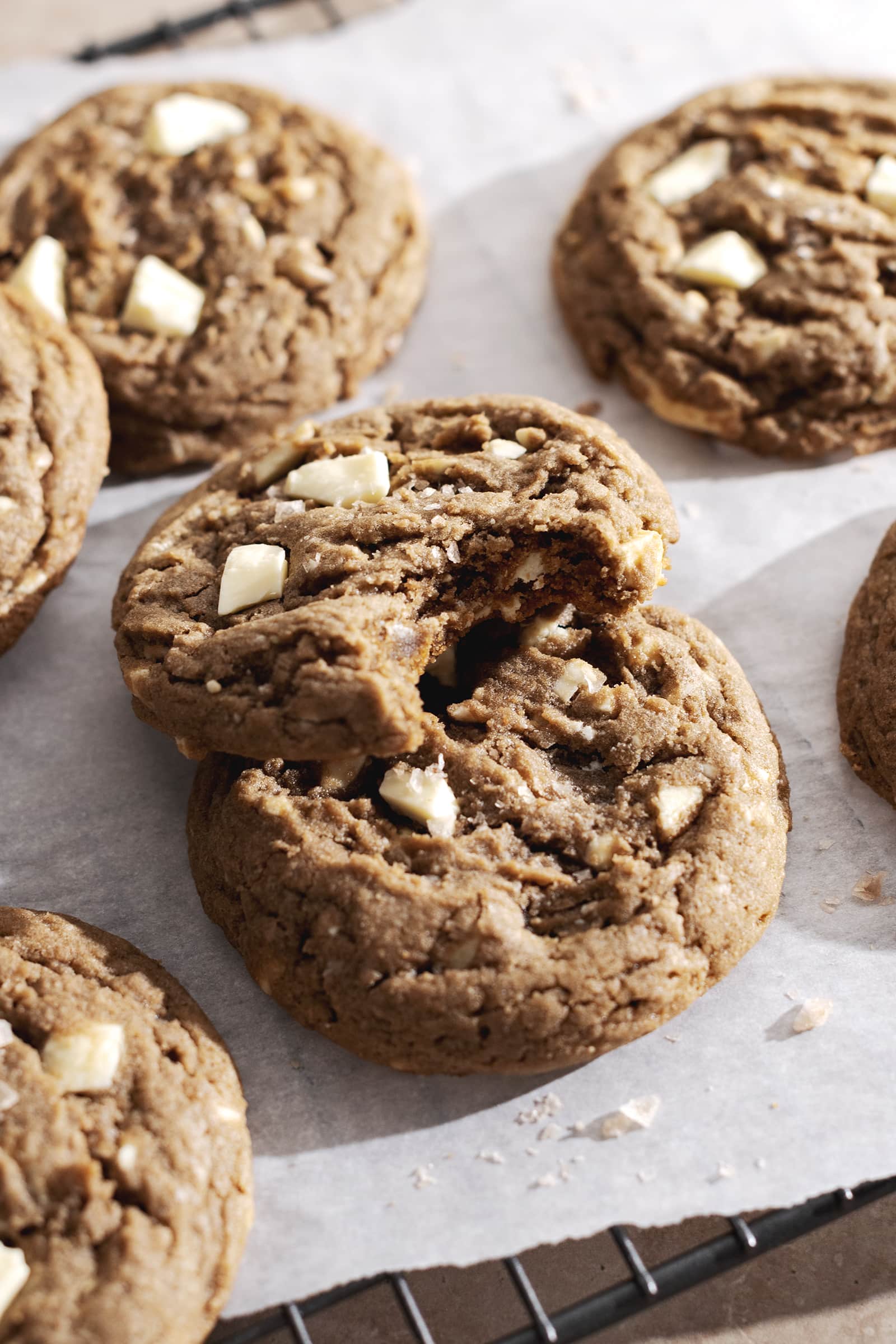 A cookie with a bite taken out of it resting on top of another cookie.