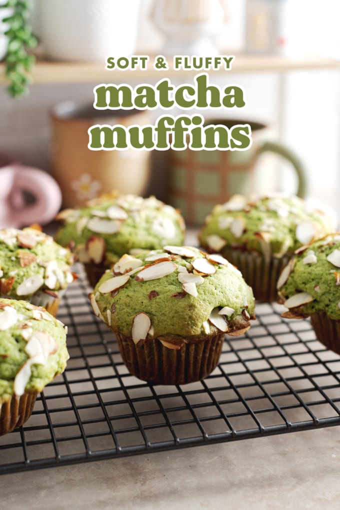 Matcha muffins topped with sliced almonds sitting on a wire rack.