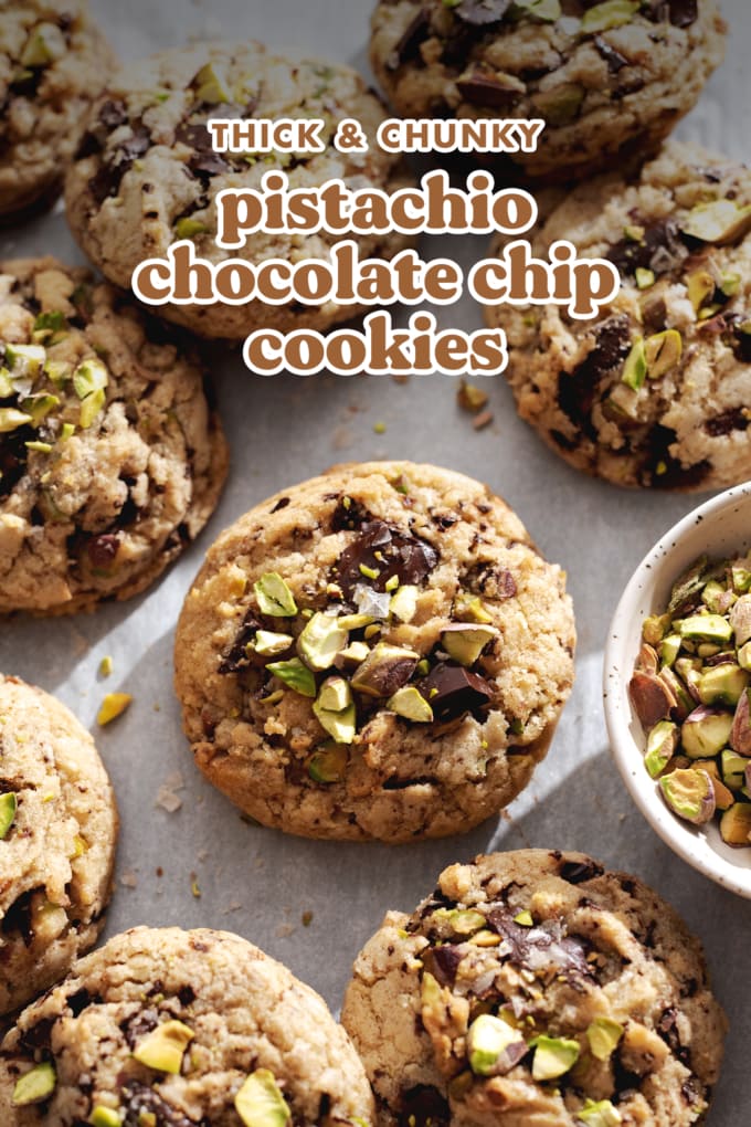 Cookies sprinkled with pistachios on parchment paper.
