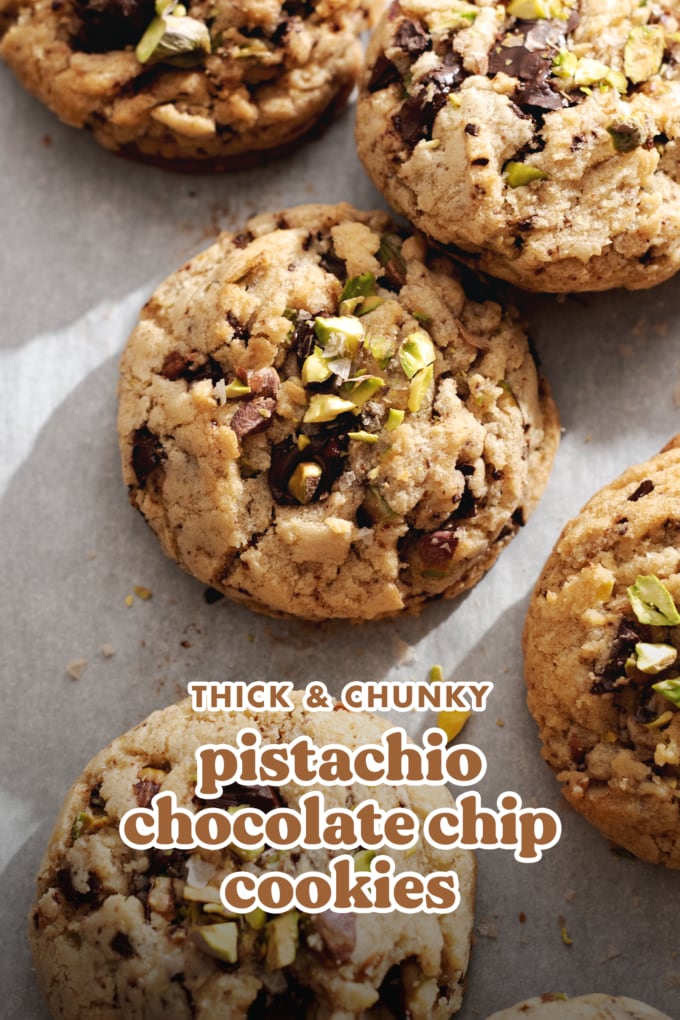 Chunky cookies scattered on parchment paper.