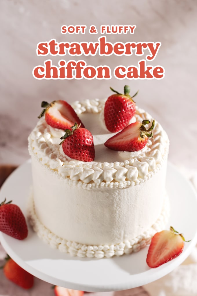 Cake covered in whipped cream and four strawberries on top.